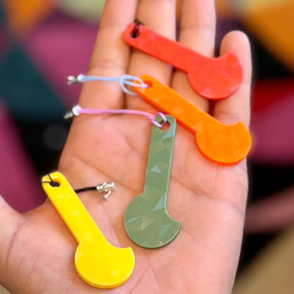 Colourful removable trolley token keyrings held in a hand